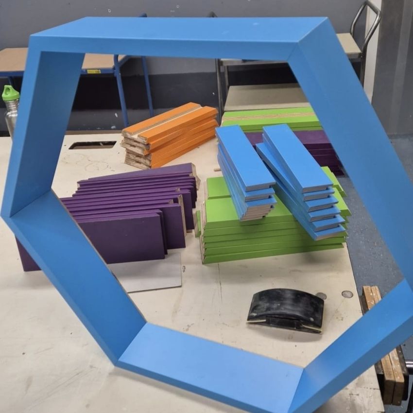 Hexagram van multiplex op HPL voor kunstwand in een middelbare school